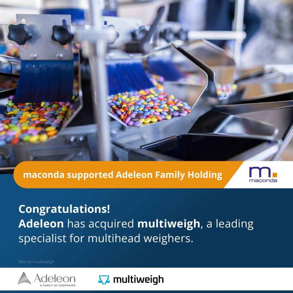 Industrial confectionery production with colorful coated sweets on a conveyor belt banner maconda supported Adeleon Family Holding