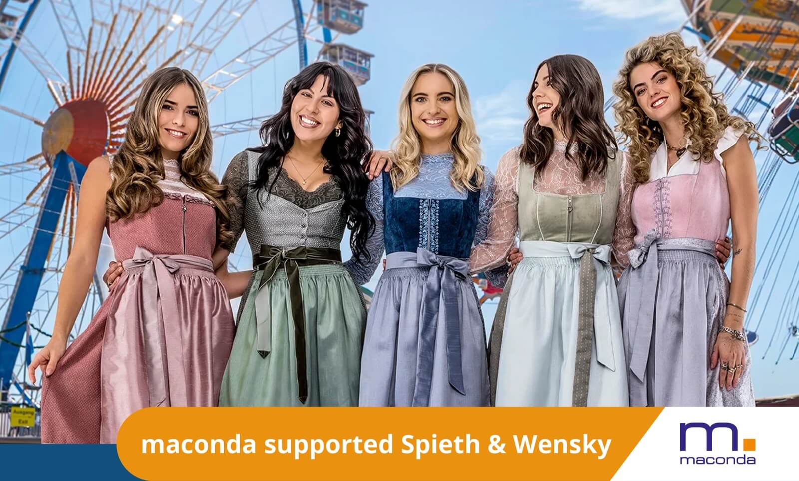 maconda News Deal Banner - Odewald KMU x S&W 250617 - maconda Five women in colorful dirndls stand arm in arm in an amusement park in front of a Ferris wheel orange banner maconda supported Spieth & Wensky
